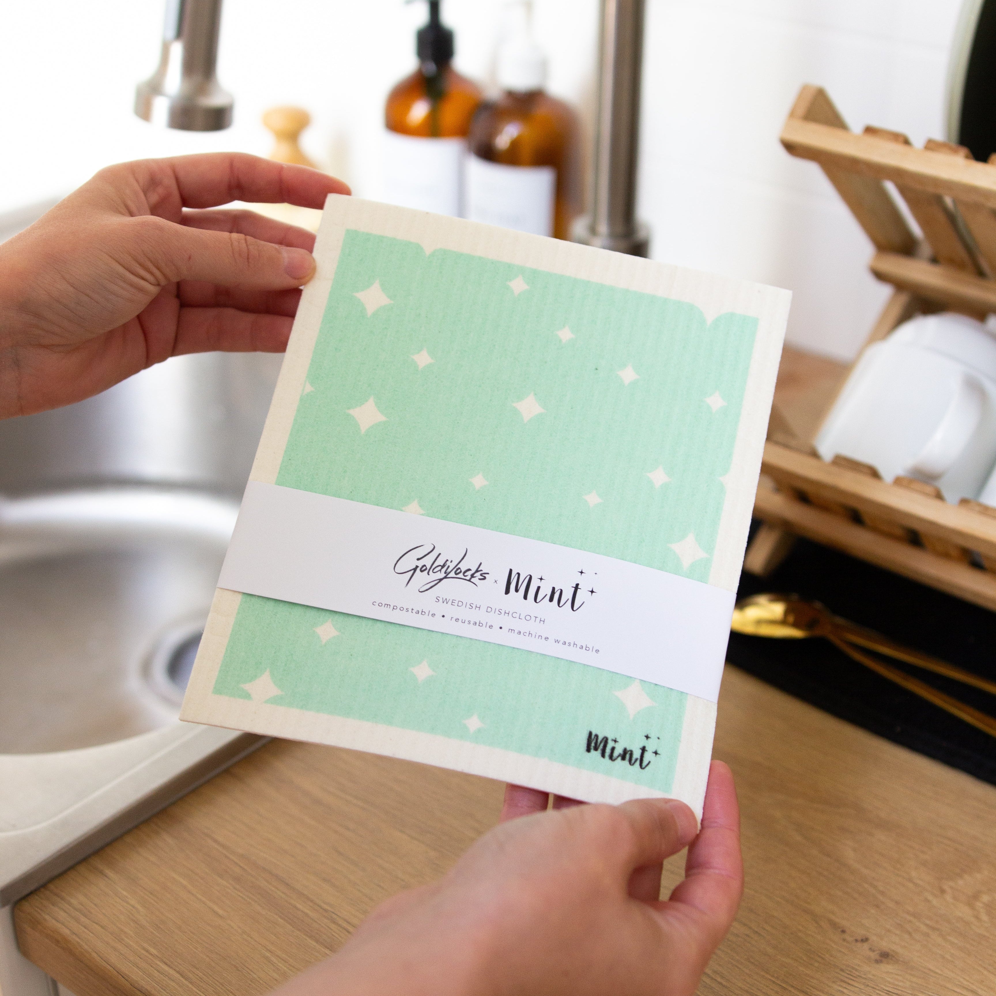 person holding a mint and white swedish dishcloth