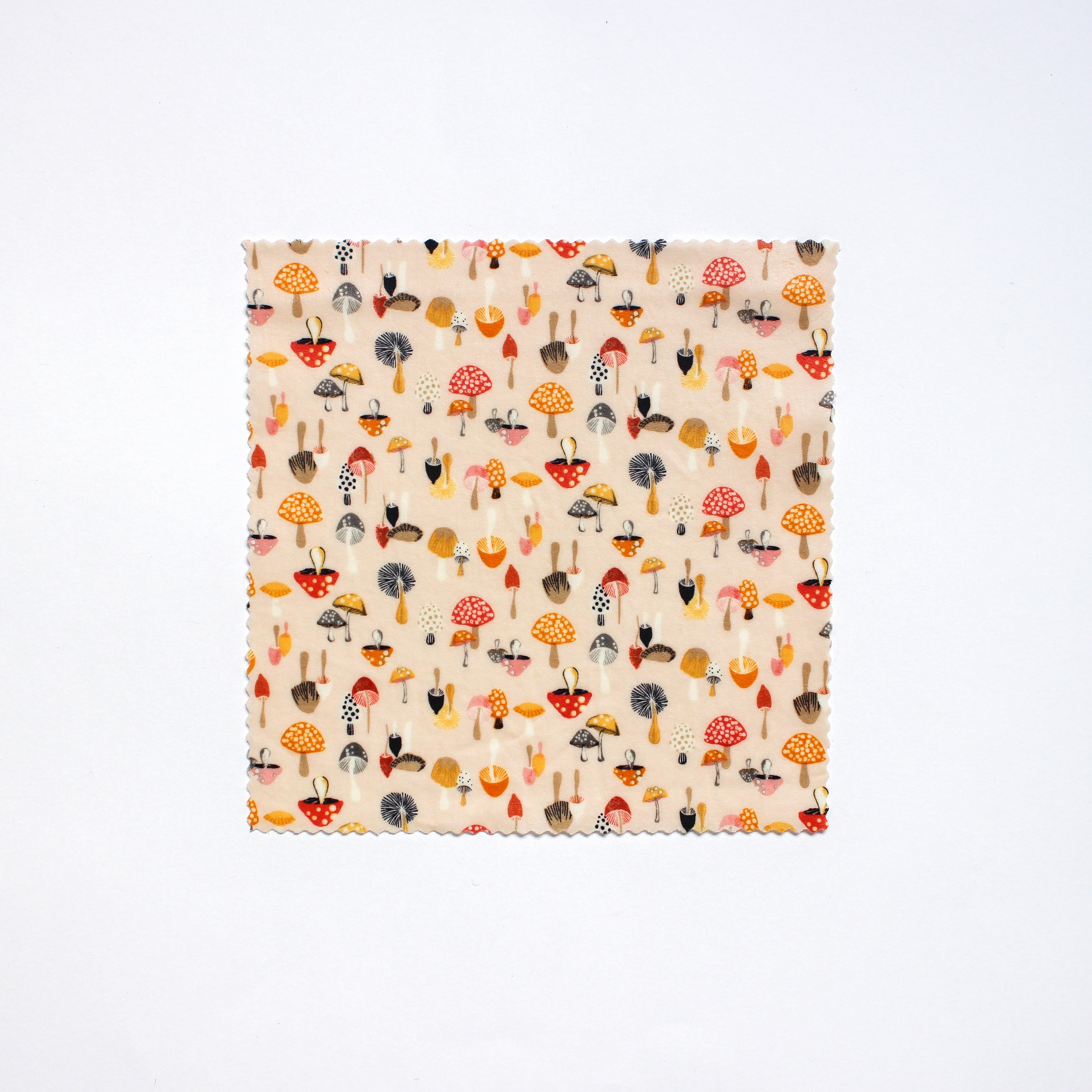 a medium beeswax food wrap featuring brightly coloured mushrooms of all different shapes, colours and sizes