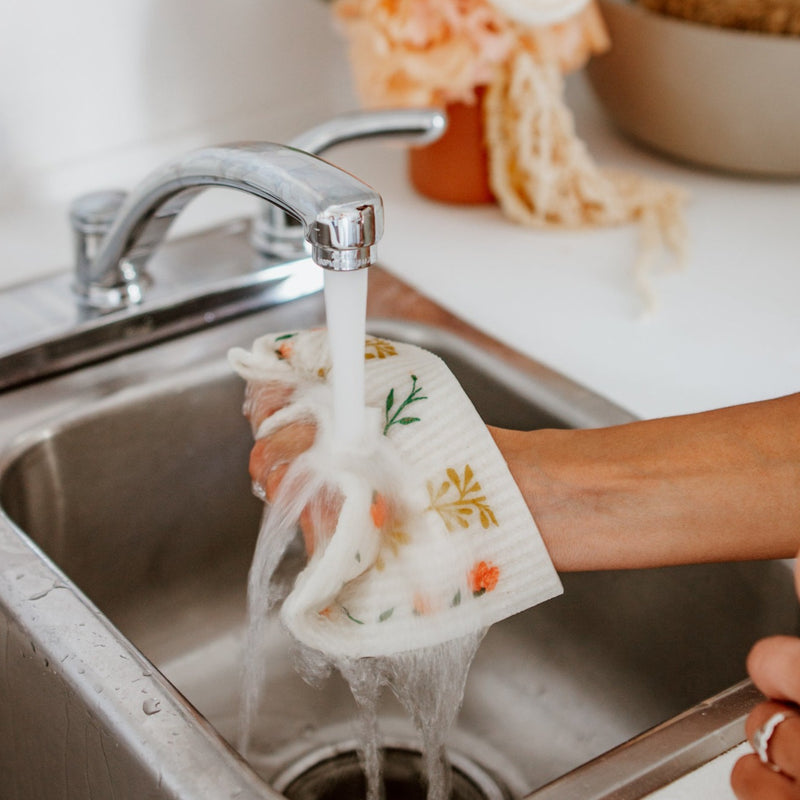 reusable dish sponge under running water
