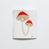 Swedish dishcloth featuring two bright red capped mushrooms with cream coloured stems