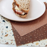 Terrazzo set of 3 beeswax wraps flat lay under sandwich on plate