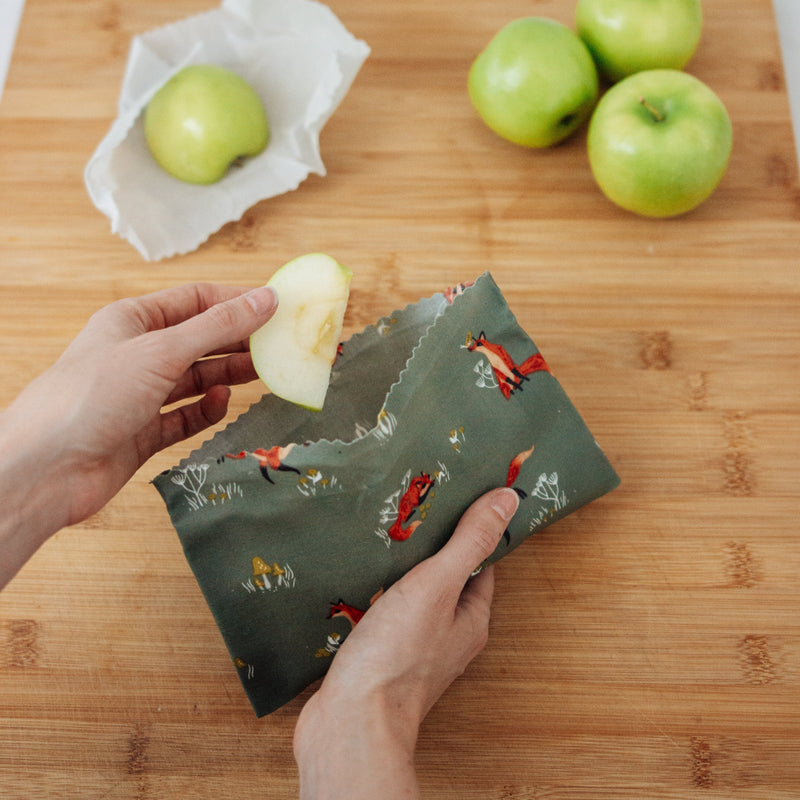 friendly foxes single medium beeswax wrap made into a snack pocket with sliced apples inside